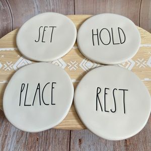 NWOT Rae Dunn 4 piece whit & black coaster set. 4” in diameter.